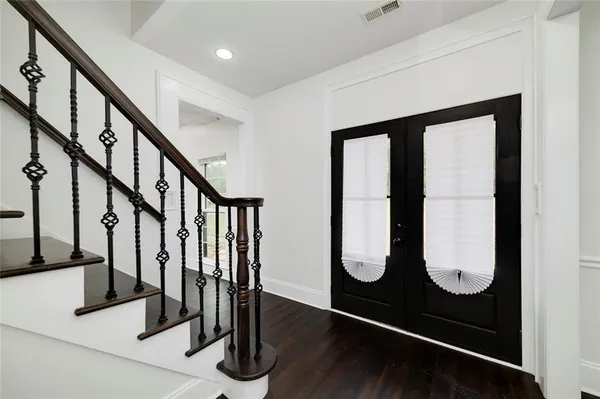 a view of entryway and hall with wooden floor