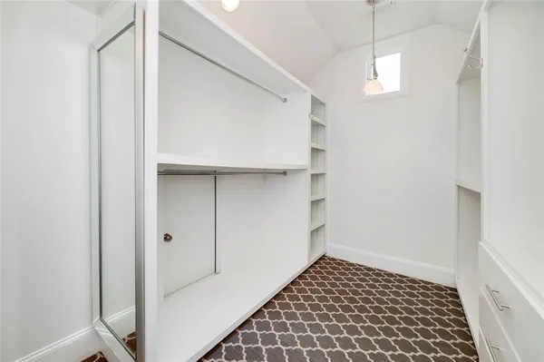 a bathroom with a granite countertop sink mirror vanity and toilet