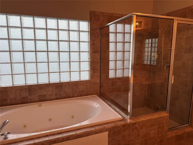 a bathroom with a bathtub and shower