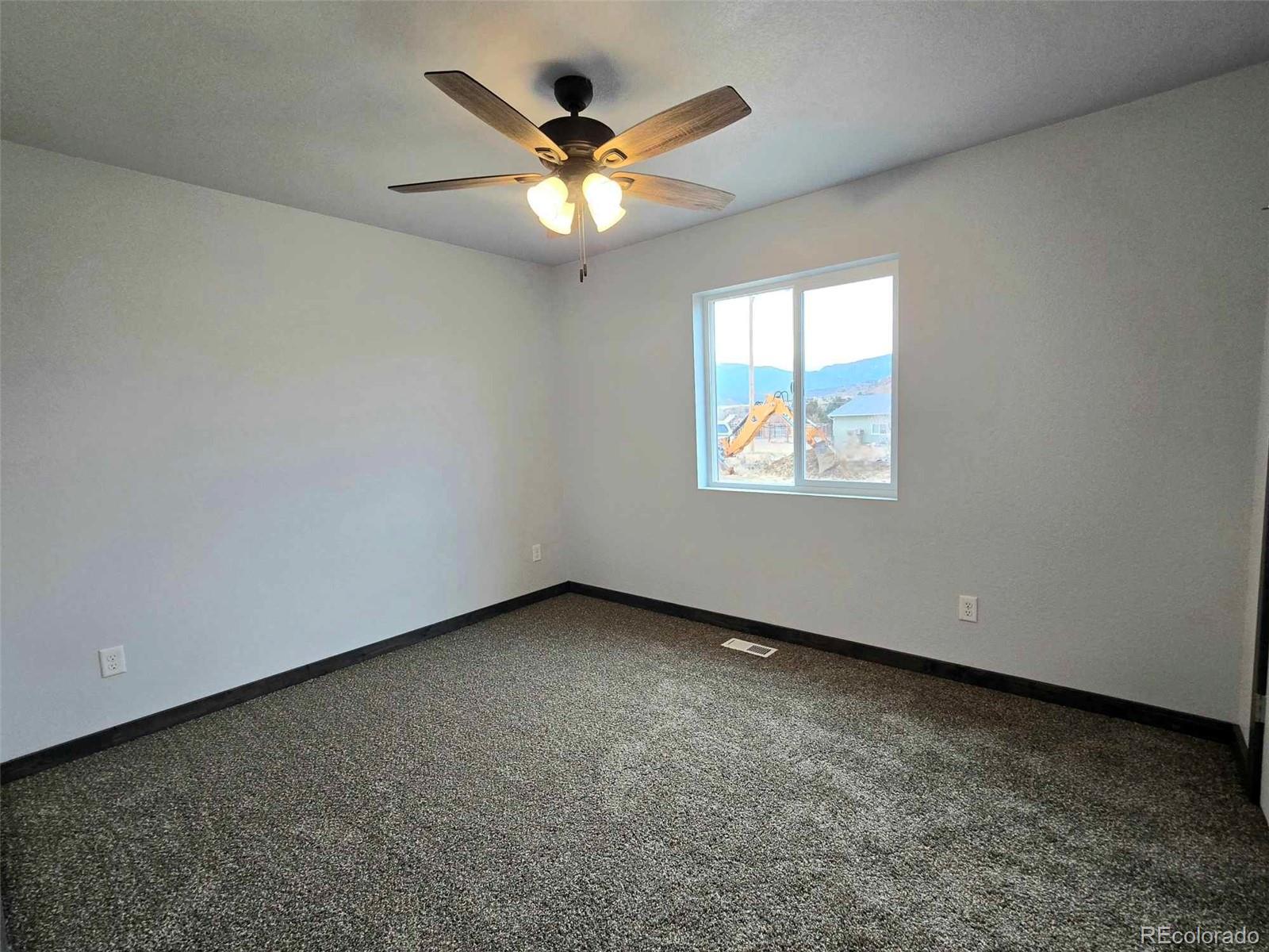 121 Quincy Street Florence, CO 81226 - Photo 15 of 23 an empty room with windows and fan