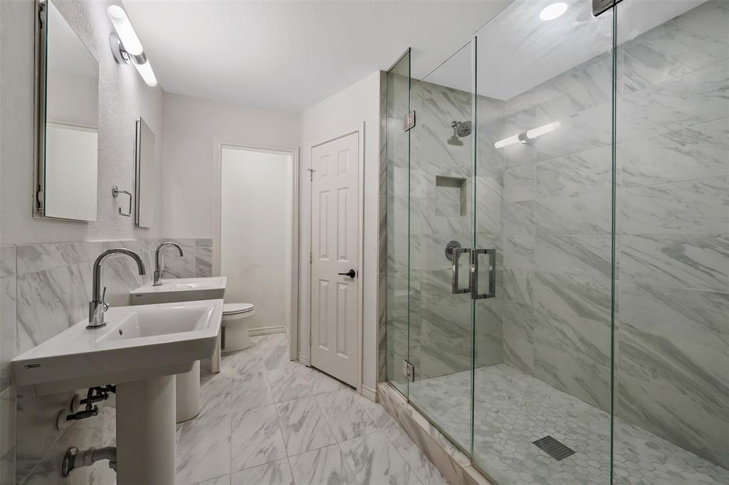 300 Rash Lane Terrell, TX 75160 - Photo 14 of 28 a bathroom with a shower sink and mirror