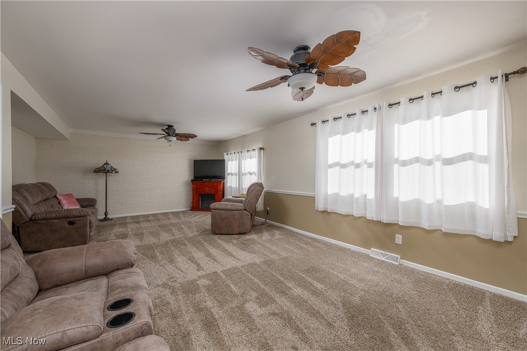 1320 Perry Drive Northwest Canton, OH 44708 - Photo 5 of 34 Unfurnished living room featuring carpet and ceiling fan