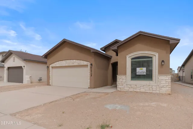 a front view of a house with a garage