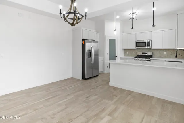 a view of a kitchen with electric appliances