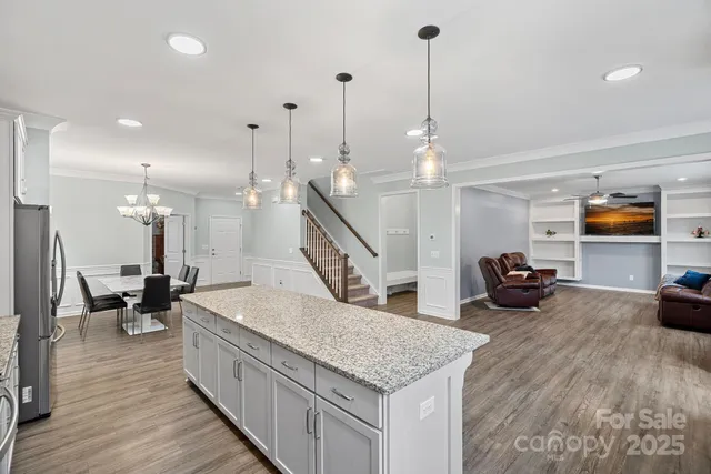 a kitchen with sink and a wooden floor