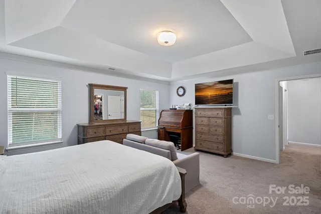 a bedroom with a bed and a television