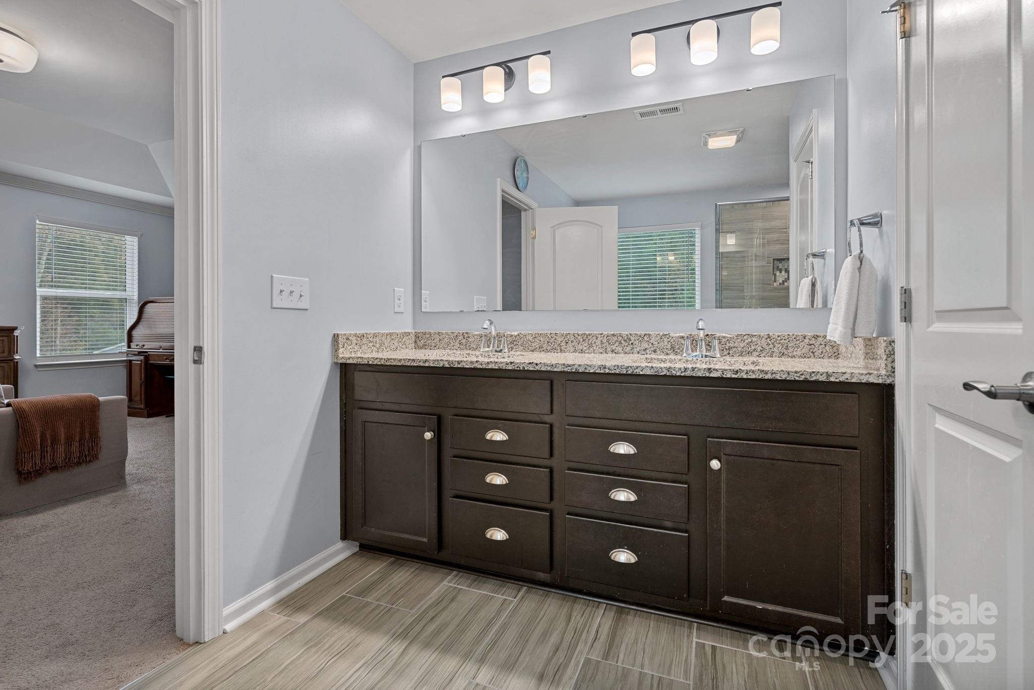 4780 Selhurst Drive Fort Mill, SC 29707 - Photo 16 of 34 a bathroom with a granite countertop sink and a mirror