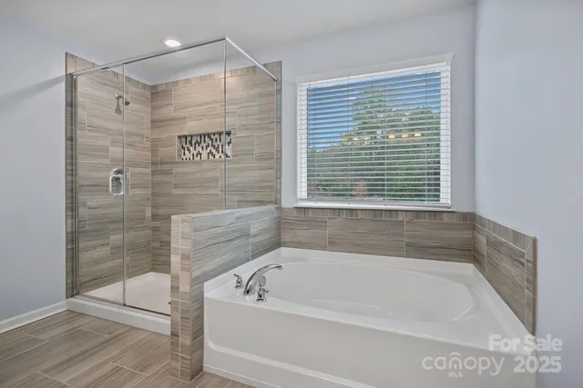 a bathroom with a bathtub and shower