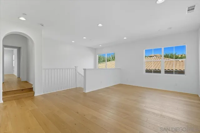 a bedroom with a bed a couch and a potted plant
