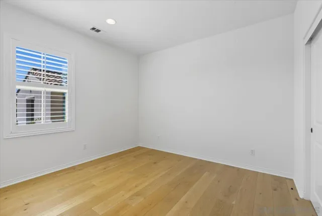 a spacious bathroom with a double vanity sink and a mirror