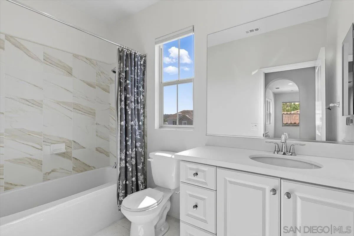 4249 Peralta Street Carlsbad, CA 92010 - Photo 19 of 49 a bathroom with a sink a toilet a tub and a mirror