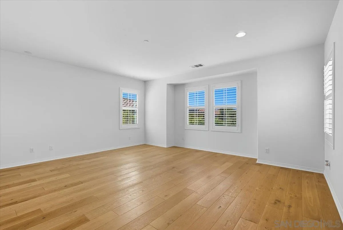 4249 Peralta Street Carlsbad, CA 92010 - Photo 24 of 49 a view of an empty room with wooden floor and a window