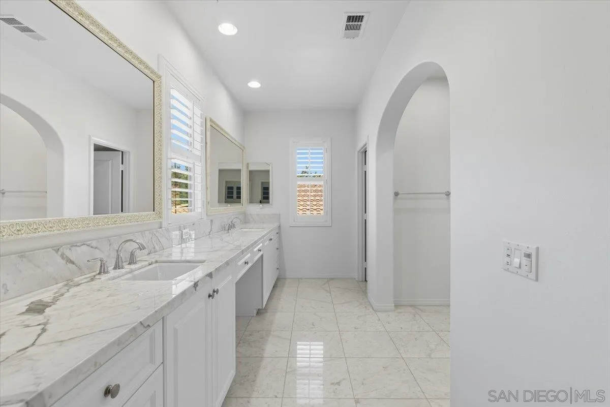 4249 Peralta Street Carlsbad, CA 92010 - Photo 29 of 49 a spacious bathroom with a double vanity sink and a mirror