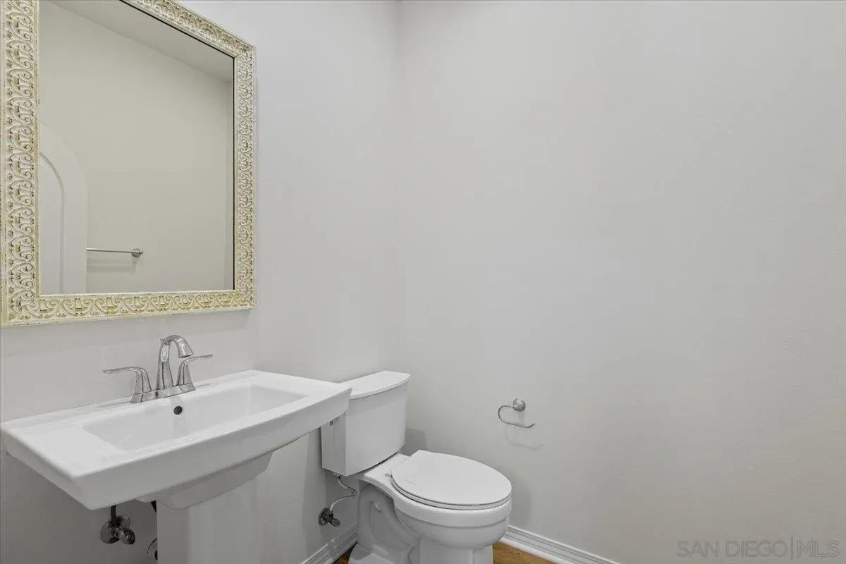 4249 Peralta Street Carlsbad, CA 92010 - Photo 32 of 49 a bathroom with a toilet a sink and mirror