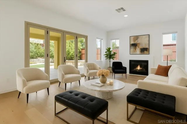 a living room with furniture a fireplace and a large window