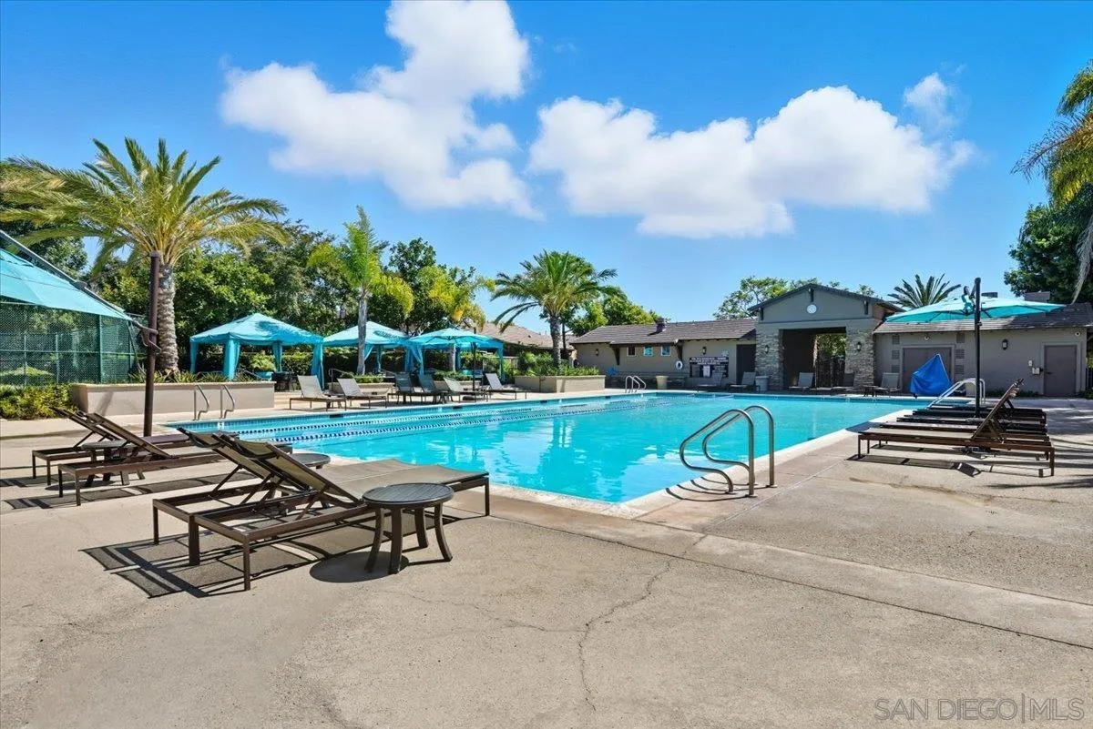 4249 Peralta Street Carlsbad, CA 92010 - Photo 45 of 49 a view of a swimming pool with lawn chairs and a fire pit