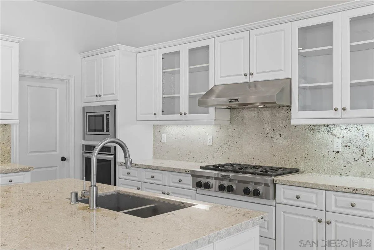 4249 Peralta Street Carlsbad, CA 92010 - Photo 9 of 49 a kitchen with stainless steel appliances granite countertop a sink stove and cabinets