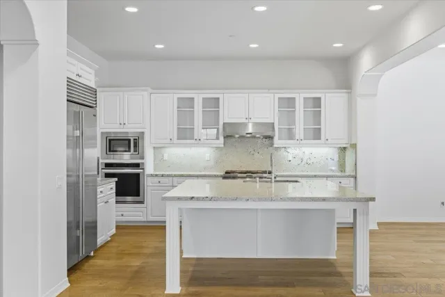 a view of entryway with wooden floor and front door