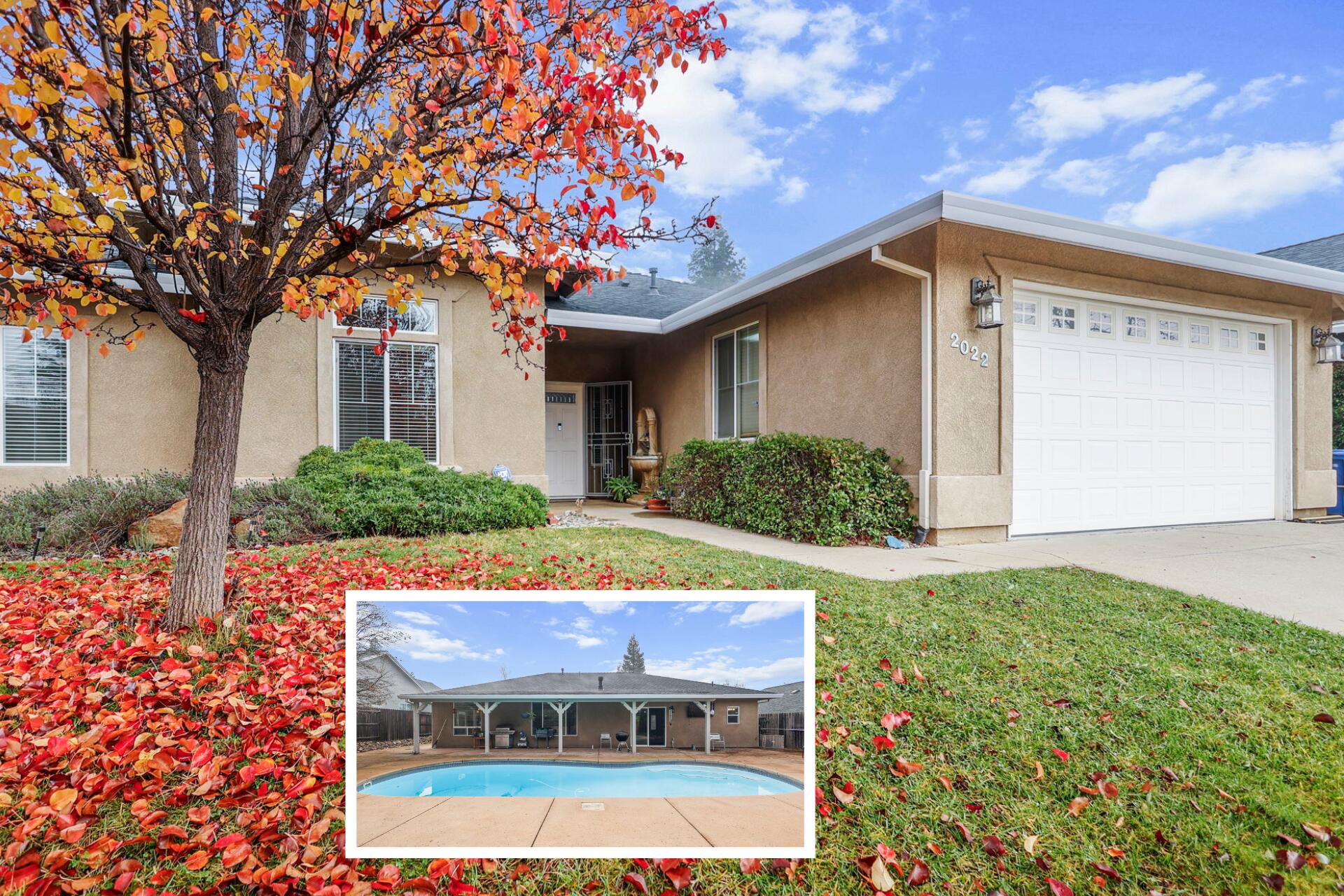 a front view of house with yard and trees around