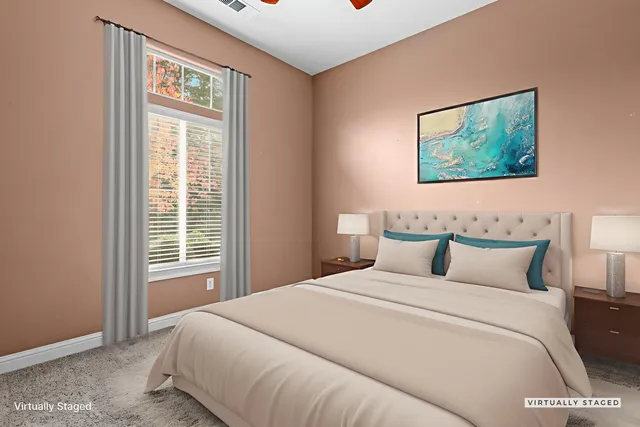 a bedroom with a large bed and a window