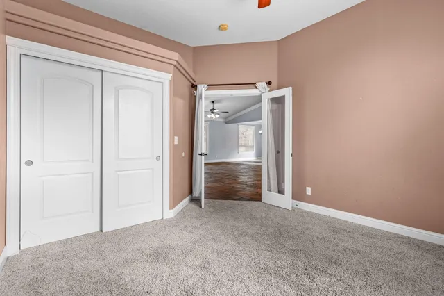 an empty room with closet and a bathroom
