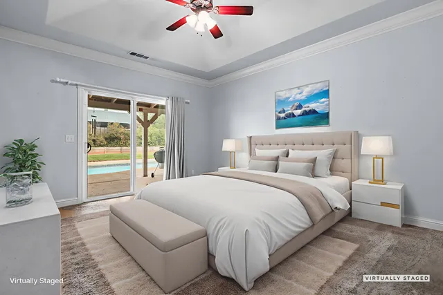 a bedroom with a large bed and a chandelier