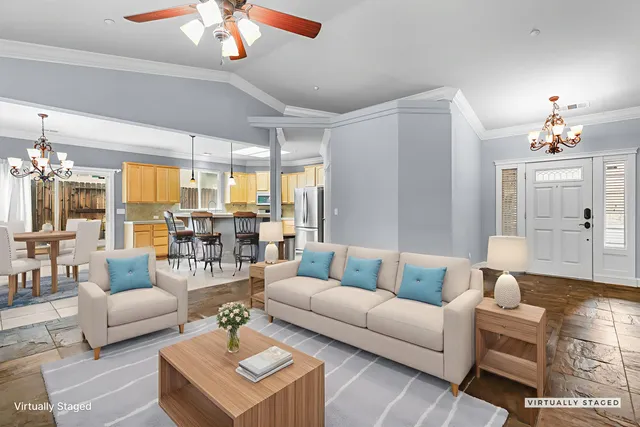 a living room with furniture a chandelier and a flat screen tv