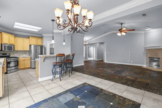 a view of a dining room with furniture and chandelier