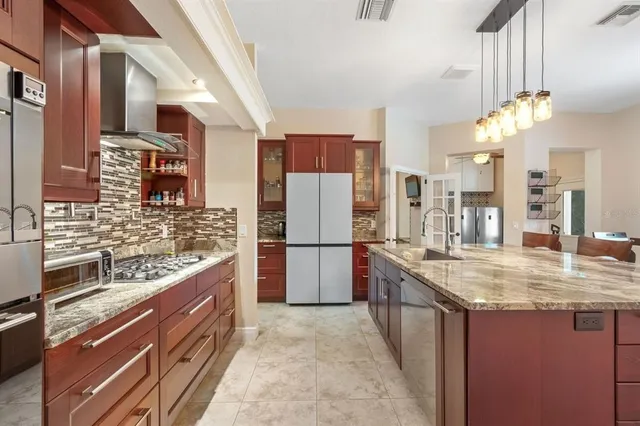 a view of a kitchen with wooden floor cabinets and windows