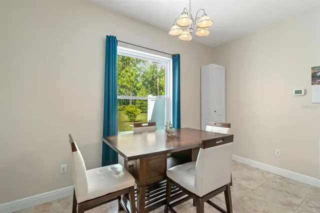 a bedroom with furniture and large windows