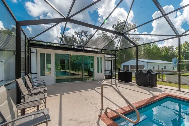 a bedroom that has a bed and a chair