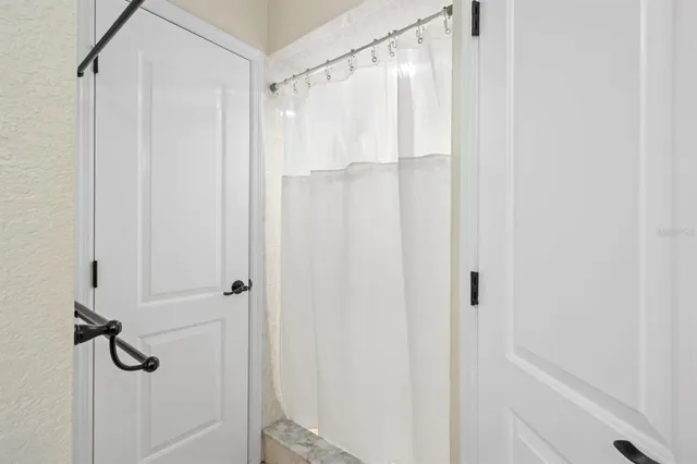 a view of a workspace with a window and a ceiling fan