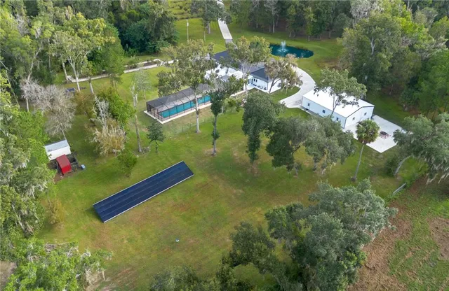 a view of a house with a big yard and potted plants