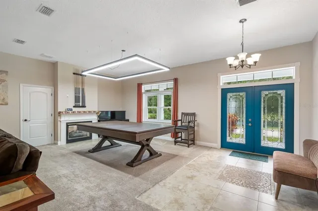 a living room with furniture a flat screen tv and kitchen view