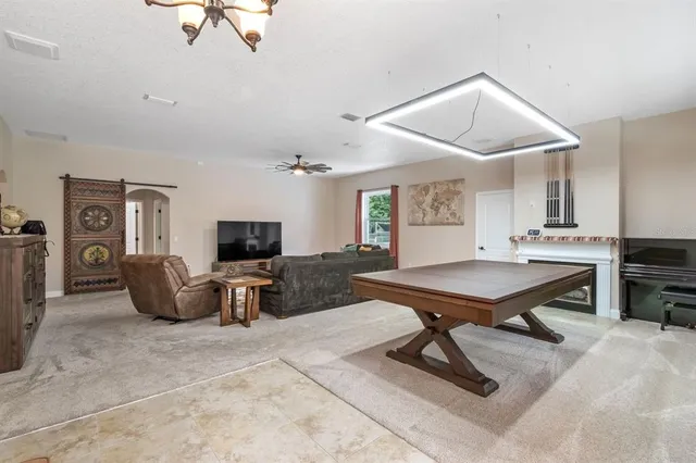 a living room with furniture ceiling fan and a window
