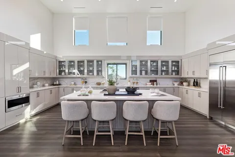 a kitchen with a stove and wooden floor