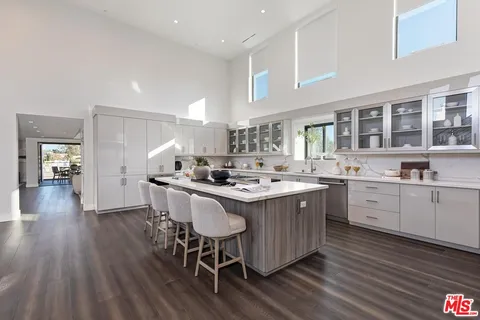 a kitchen with stainless steel appliances granite countertop a sink and stove