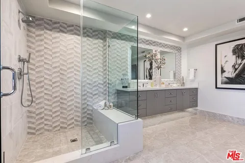 a bathroom with a sink a toilet a mirror a bathtub and shower