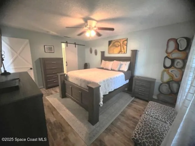 a bedroom with a bed and a television