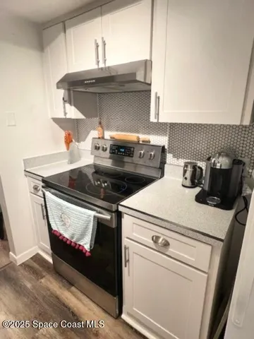 a kitchen with a stove and a microwave