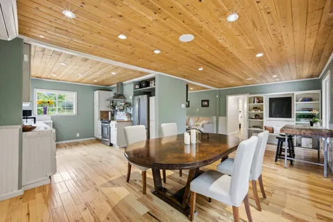a dining room with furniture and window