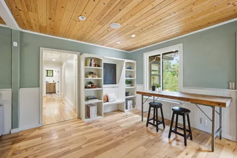a bedroom with furniture and large window