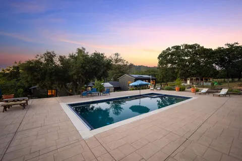 a view of a swimming pool with a mountain in the background