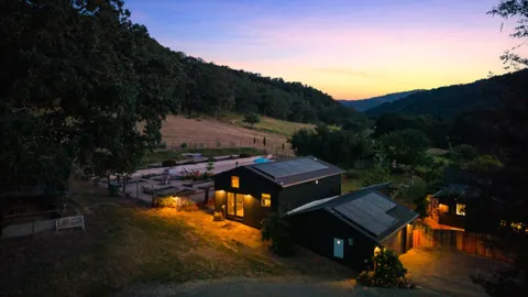 an aerial view of a house with a yard basket ball court and outdoor seating