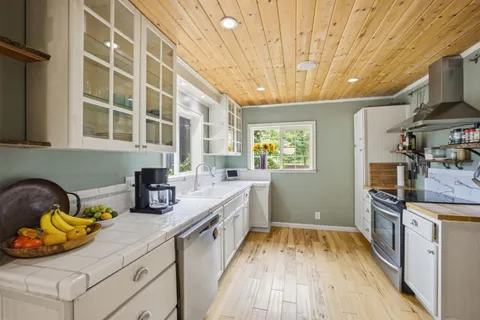 a dining room with furniture a rug and wooden floor