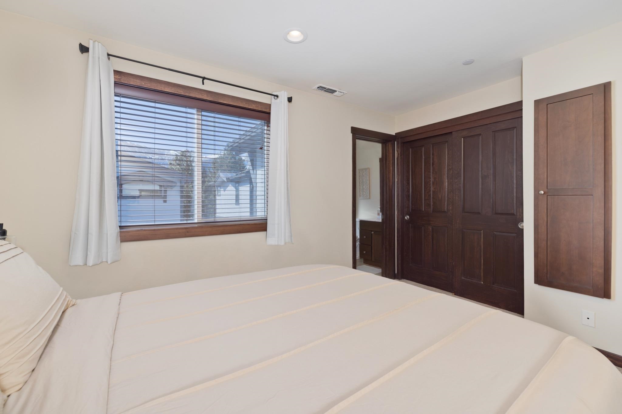 28 Oak Tree Way, Unit 8 Mammoth Lakes, CA 93546 - Photo 20 of 32 a bedroom with a large bed and a window