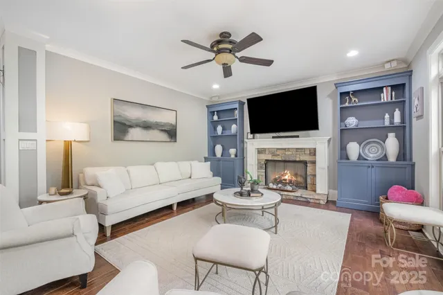 a living room with furniture a flat screen tv and a fireplace