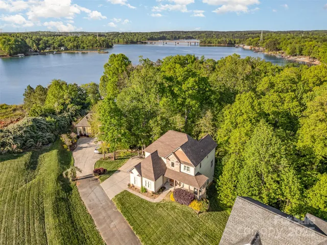 an aerial view of a house with a lake view