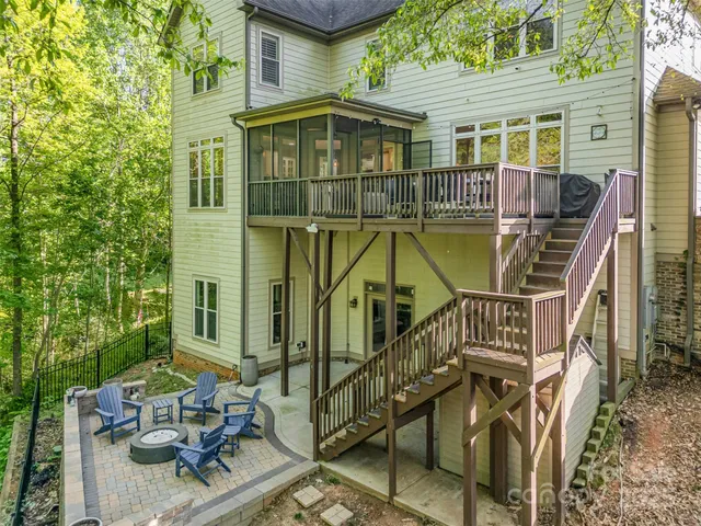 a front view of a house with glass windows and furniture