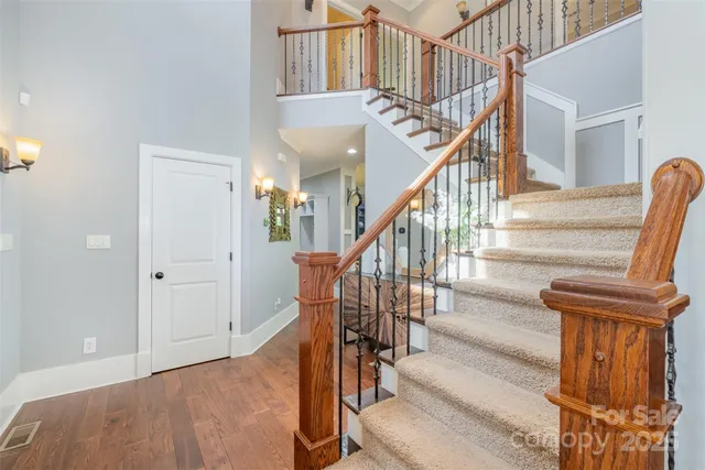 a view of staircase with wooden floor and next to a window